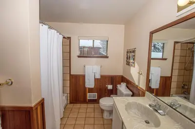 a bathroom with a toilet and a sink and a mirror at Big Pine By Hauserman Rentals in Tahoe City