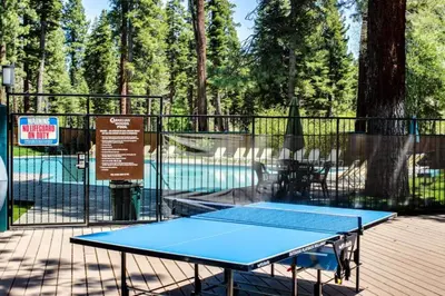 a blue ping pong table in front of a fence at Carnelian Woods # 11 By Hauserman Rentals in Carnelian Bay