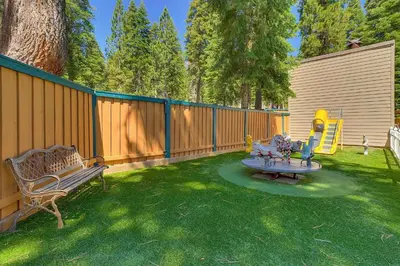 a backyard with a bench and a playground at Carnelian Woods # 11 By Hauserman Rentals in Carnelian Bay