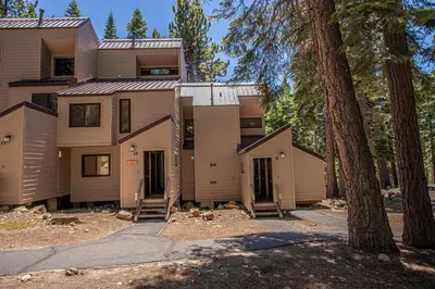 a house with trees in front of it at Carnelian Woods # 11 By Hauserman Rentals in Carnelian Bay