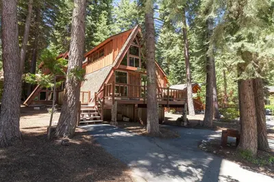 a log cabin in the woods with trees at Hoeck Hacienda By Hauserman Rentals in Tahoe City
