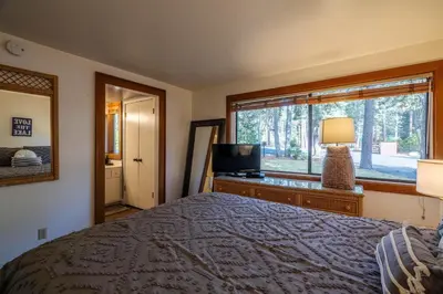 a bedroom with a bed and a television and a window at NorthShore # 47 By Hauserman Rentals in Tahoe City