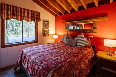 a red bedroom with a bed and a window at NorthShore # 47 By Hauserman Rentals in Tahoe City