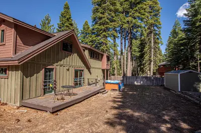 a backyard of a house with a wooden deck at Bonanza By Hauserman Rentals in Tahoe City
