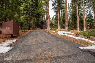 an empty road in the middle of a forest at Rockwood By Hauserman Rentals in Carnelian Bay