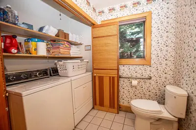 a small bathroom with a toilet and a washer at Celtic Lodge By Hauserman Rentals in Homewood