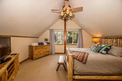 a bedroom with a bed and a ceiling fan at Carnelian Bay Hideaway By Hauserman Rentals in Carnelian Bay