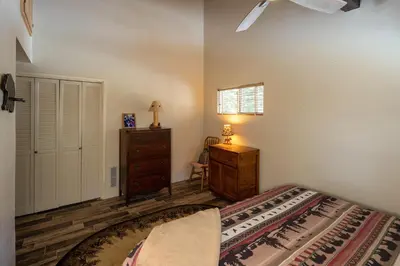 a bedroom with a bed and a dresser and a window at Catalpa Vista By Hauserman Rentals in Tahoe Vista