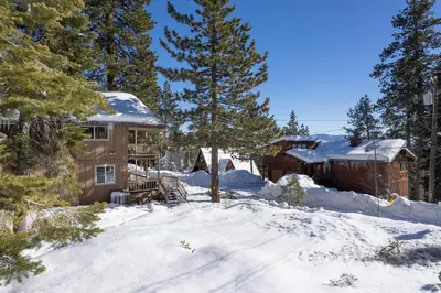 a house in the snow with snow covered trees at Catalpa Vista By Hauserman Rentals in Tahoe Vista