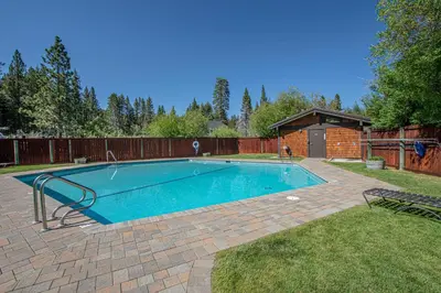 a swimming pool in a yard with a fence at Star Harbor # 10 By Hauserman Rentals in Tahoe City