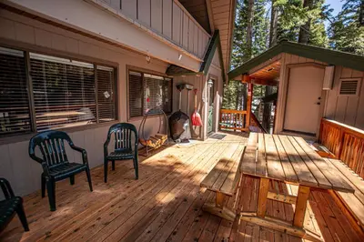 a porch of a house with two chairs and a table at Das Berghaus By Hauserman Rentals in Tahoe City