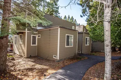 a house with a garage in the woods at Dollar Hill II # 49 By Hauserman Rentals in Tahoe City