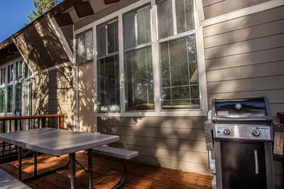 a patio with a grill and a picnic table on a porch at Dollar Hill II # 49 By Hauserman Rentals in Tahoe City
