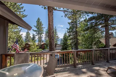 a patio with a table and chairs on a deck at Coates By Hauserman Rentals in Tahoe City