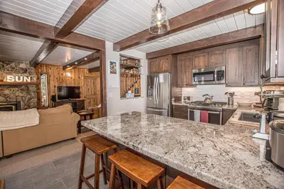 a kitchen with a large counter and wooden cabinets at Edelweiss Escape By Hauserman Rentals in Tahoe City