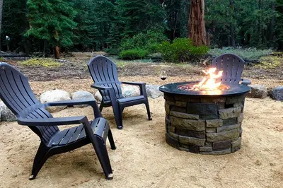 two chairs and a fire pit in a yard at Edelweiss Escape By Hauserman Rentals in Tahoe City
