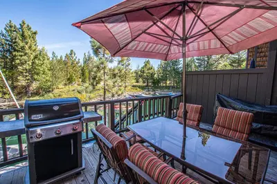 a grill on a deck with a table and chairs at Star Harbor # 27 By Hauserman Rentals in Tahoe City