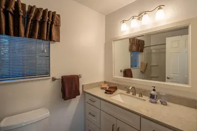a bathroom with a sink and a mirror at Grainger By Hauserman Rentals in Tahoe City