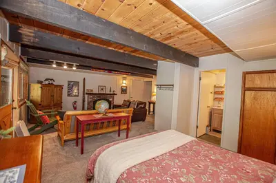 a bedroom with a bed and a living room at Alpine Welcome By Hauserman Rentals in Tahoe City