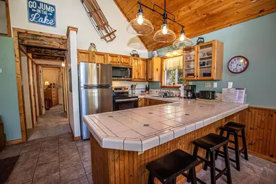 a kitchen with a large counter and stools in it at Alpine Welcome By Hauserman Rentals in Tahoe City
