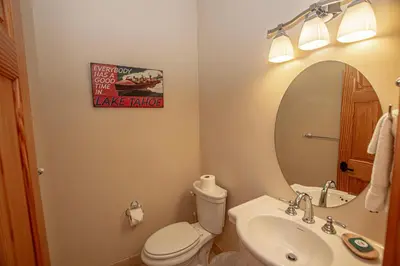 a bathroom with a toilet and a sink and a mirror at Tahoe Woods By Hauserman Rentals in Tahoe City