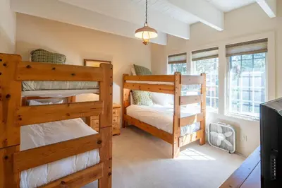a bedroom with two bunk beds and a tv at Dollar Point Lodge By Hauserman Rentals in Tahoe City