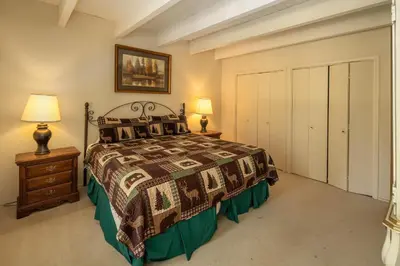 a bedroom with a bed and two lamps and a closet at Dollar Point Lodge By Hauserman Rentals in Tahoe City