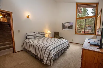a bedroom with a bed and a desk and a window at Vance By Hauserman Rentals in Tahoe City