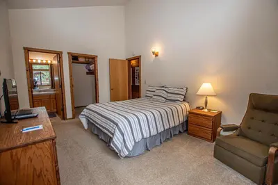 a bedroom with a bed and a couch and a chair at Vance By Hauserman Rentals in Tahoe City