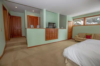a bedroom with a bed and a couch in a room at Snow Crest By Hauserman Rentals in Alpine Meadows