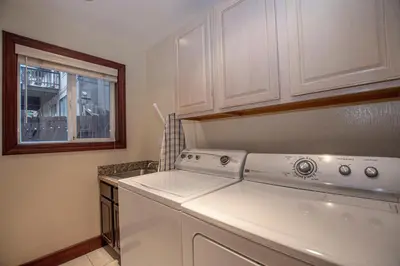 a kitchen with a washing machine and a window at Highlands Lodge By Hauserman Rentals in Tahoe City