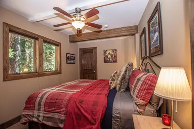 a bedroom with a bed and a ceiling fan at Black Bear Haus By Hauserman Rentals in Tahoe City