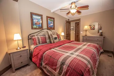 a bedroom with a bed and a ceiling fan at Black Bear Haus By Hauserman Rentals in Tahoe City