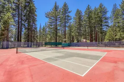 a tennis court with two tennis rackets on it at Carnelian Woods #126 By Hauserman Rentals in Carnelian Bay