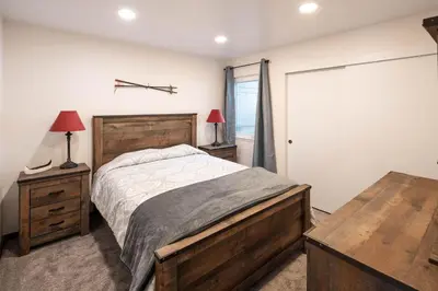 a bedroom with a large bed and a table at Carnelian Woods #126 By Hauserman Rentals in Carnelian Bay
