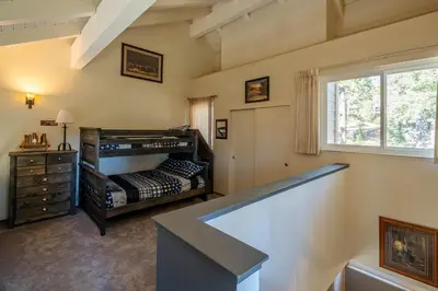 a bedroom with a bunk bed and a window at Carnelian Woods #126 By Hauserman Rentals in Carnelian Bay