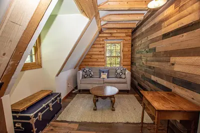 a living room with a couch and a table at Little Bear Cabin By Hauserman Rentals in Tahoe Vista