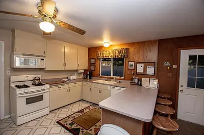 a kitchen with white appliances and a ceiling fan at Holland By Hauserman Rentals in Homewood