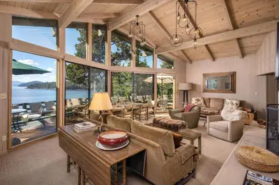 a living room filled with furniture and windows at McCown Lakefront By Hauserman Rentals in Tahoma