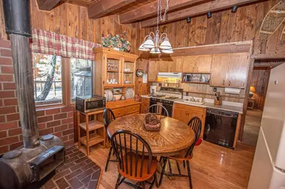 a kitchen with a table and chairs and a stove at Plesums By Hauserman Rentals