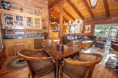 a kitchen and living room with a table and chairs at Home Swede Home By Hauserman Rentals in Tahoe City