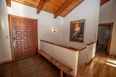 a hallway with a staircase and a movie poster on the wall at Home Swede Home By Hauserman Rentals in Tahoe City