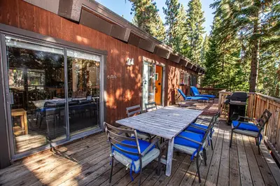 a wooden table and chairs on a deck at Home Swede Home By Hauserman Rentals in Tahoe City