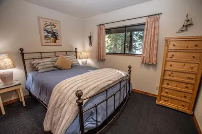 a bedroom with a bed and a dresser and a window at Home Swede Home By Hauserman Rentals in Tahoe City