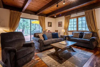 a living room with two couches and a coffee table at Molly's Treehouse By Hauserman Rentals in Carnelian Bay