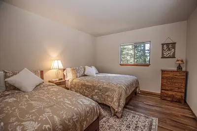 a bedroom with two beds and a window at Casa Pasquale By Hauserman Rentals in Carnelian Bay