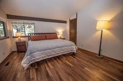 a bedroom with a bed and two lamps in it at Casa Pasquale By Hauserman Rentals in Carnelian Bay