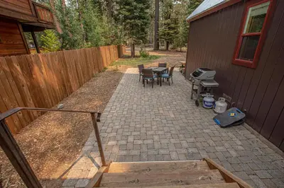 a backyard with a table and chairs and a fence at O'Brien's Den By Hauserman Rentals in Tahoma