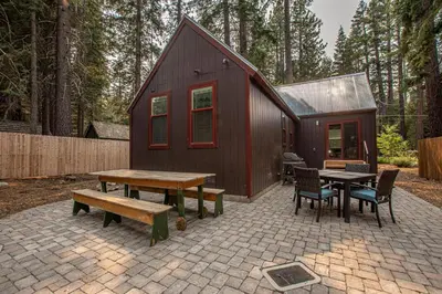 a small cabin with a picnic table and a bench at O'Brien's Den By Hauserman Rentals in Tahoma