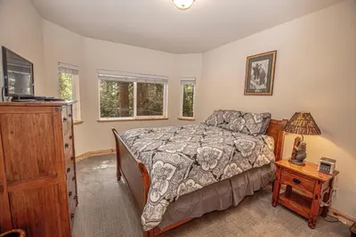 a bedroom with a bed and a dresser at Sherman By Hauserman Rentals in Tahoma